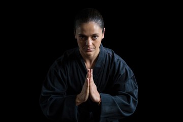 Female karate player in prayer pose - Powered by Adobe