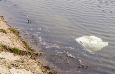 Plastic bag in dirty water