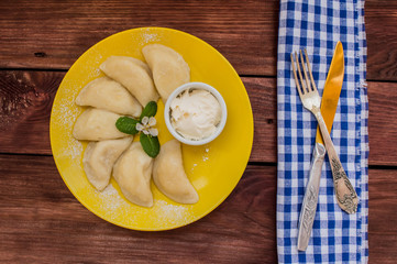 Dumplings with cheese for breakfast. Wooden table. Top view