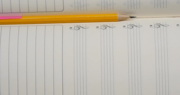 Pencil on music note book in rotation