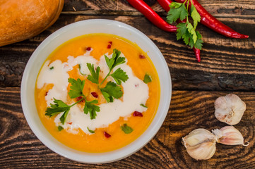 Soup with pumpkin and cream. On a wooden background. Top view