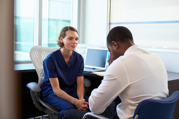 Fototapeta premium Doctor In Consultation With Depressed Male Patient