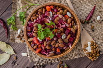 Salad Vinaigrette of beets on a wooden background. Top view