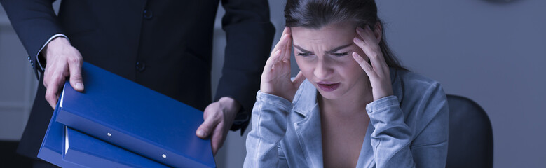 Stressed worker holding her head