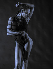 Fototapeta na wymiar Fitness Model on black background 