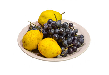 Yellow pear and grapes on the plate