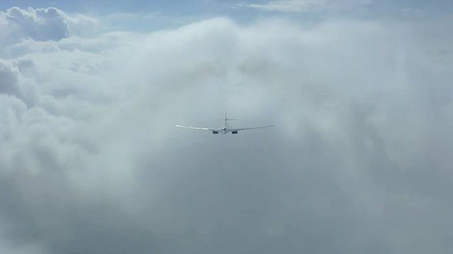 The plane is flying through the clouds