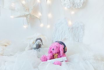 Plush pink dog, little Santa Claus with Christmas white background
