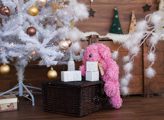 Plush pink dog with a Christmas tree