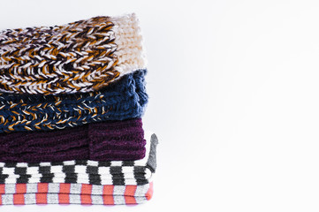pile of multicolored knitwear isolated on white background