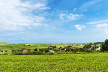 Landscape of meadows with several farms in Cantabria, Spain