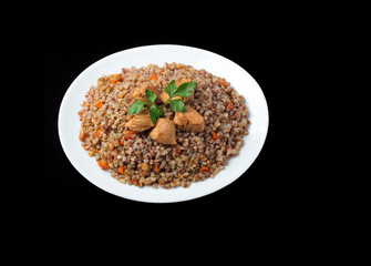  meat with buckwheat on white plate.