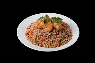 Healthy food. Buckwheat with meat and vegetables on white plate