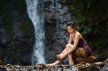 Asian woman wearing traditional thai take a baht on during sunset,vintage style,Beautiful woman take a baht,woman take a baht in river,Woman thai culture