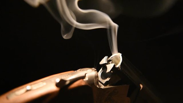 Smoke from the trunks of smooth-bore hunting rifle after firing.
