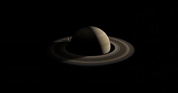 Satellite or moon orbitin over rings of planet Saturn