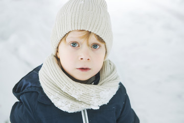 boy with big eyes n a snowy day 