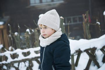 fashion boy outdoors in a snowy day