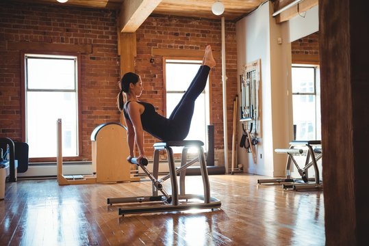 Woman practicing pilates in fitness studio