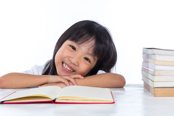 Smiling Asian Chinese little girl reading book
