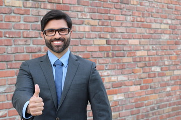 Excited businessman gesturing thumbs up