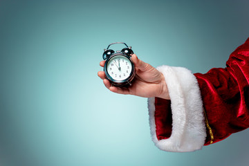 Santa holding an old alarm clock