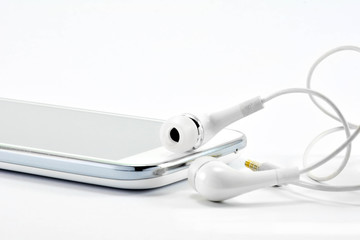 The white smart-phone and white earphones on the white background isolate.
