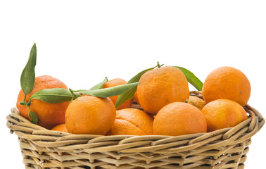 Oranges and tangerines in basket isolated on white background. C