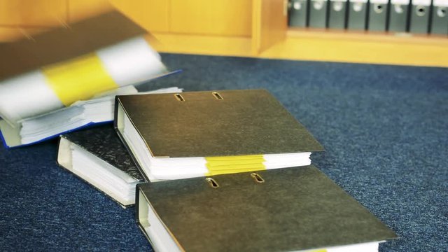 The files with paper fall down on carpet in office