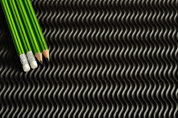 Green and black writing pencils