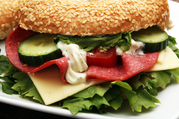 Delicious bagel sandwich with Lettuce and Tomato on the table