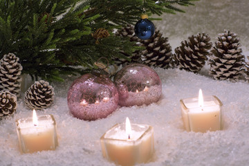 Christmas still life is with snow. Pink glass ball is near the Christmas tree.  