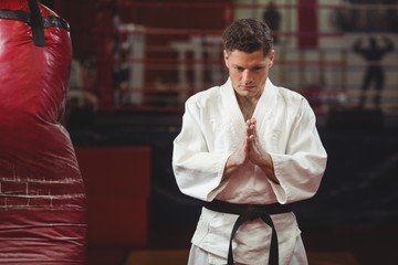 Karate player in prayer pose - Powered by Adobe