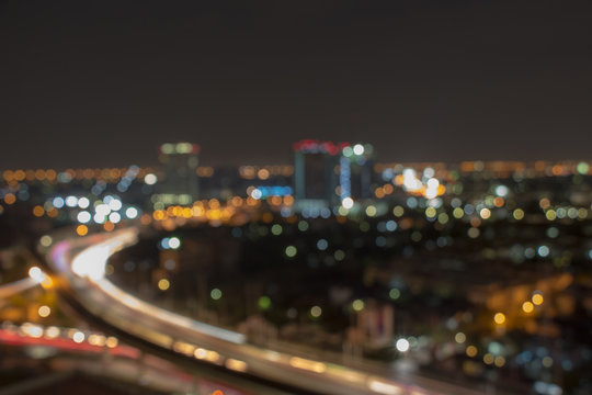 Blurred city skyline at night for corporate business concepts and urban city planning. Skyscrapers at twilight.