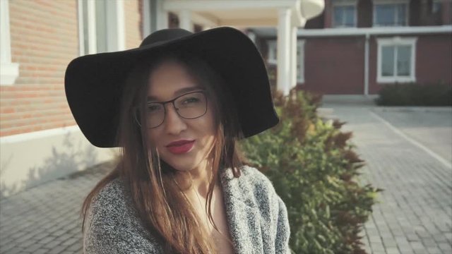 Close up portrait of pretty smiling woman in black hat and glasses outdoor HD
