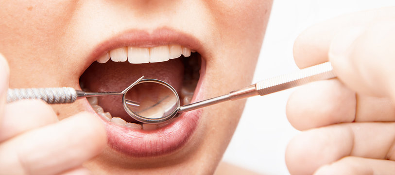 Doctor doing dental treatment to his patient in clinic.
