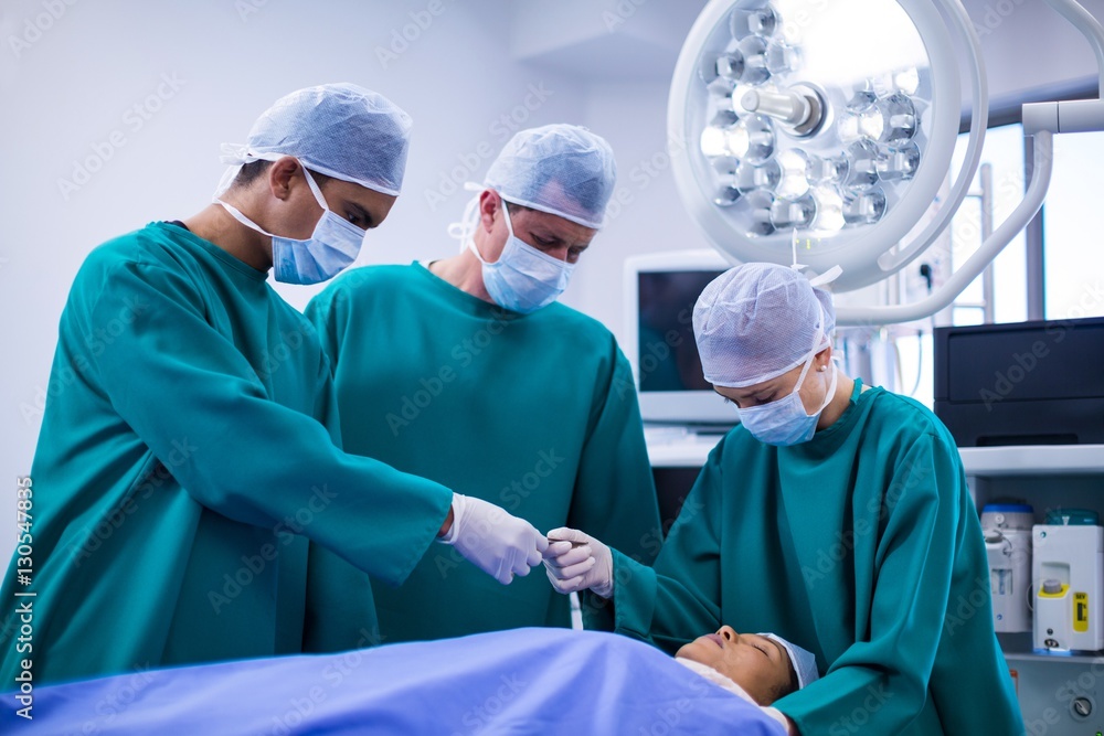 Poster surgeons performing operation in operation theater