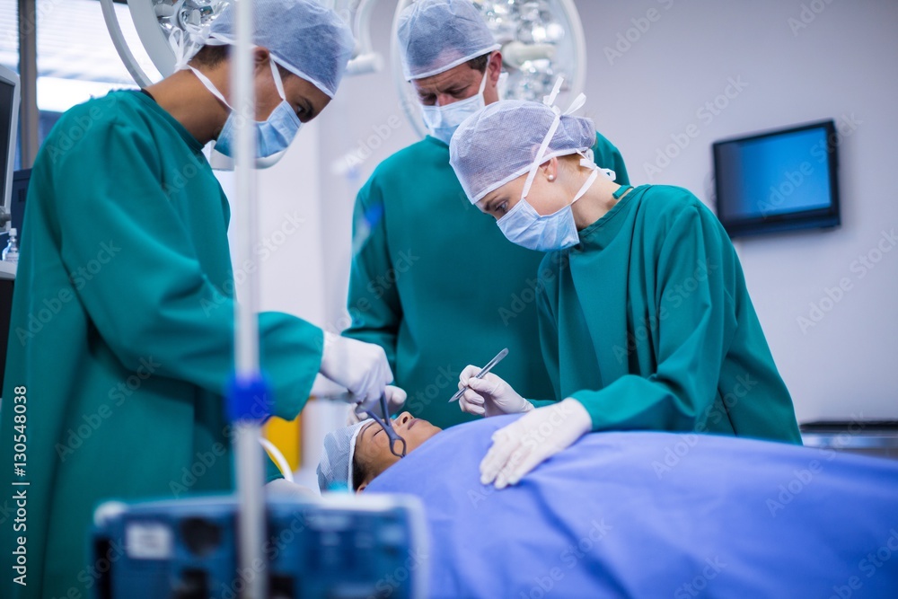 Poster surgeons performing operation in operation theater