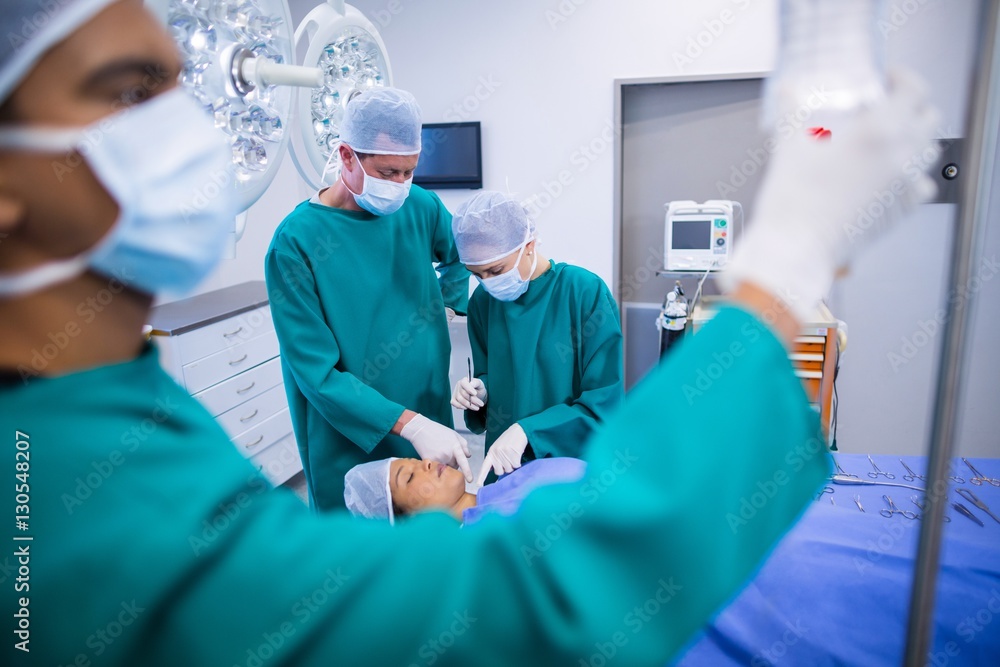 Poster surgeons performing operation in operation theater