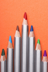 Set of colored pencils for drawing on a orange
 background.