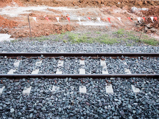 single railways and chock and gravel partition construction area by red and white pennant
