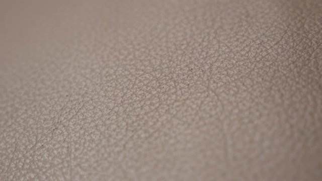 Fine brown contemporary dark sofa texture slow pan 3840X2160 UHD footage - Animal skin leather sofa detailed surface shallow DOF panning 4K 2160p UHD video 