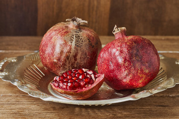 Ripe pomegranate fruit on wooden background.