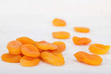 Pile of healthy, delicious dry apricots over white