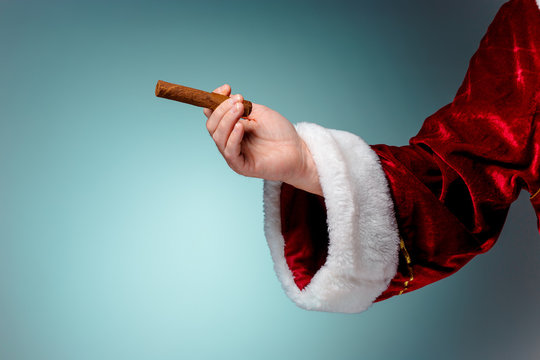 Photo of Santa Claus hand with a cigar