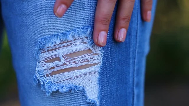 Woman wearing ripped jeans