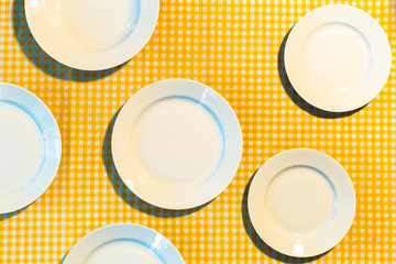 the plate on yellow checkered table cloth