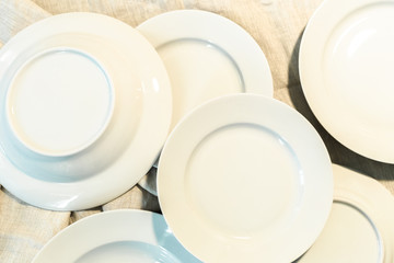Empty white plates on wooden table