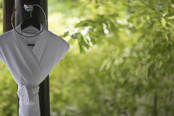 White bathrobe hanging on a hanger in a bathroom design in the o