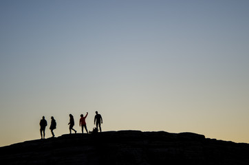 Fototapeta na wymiar A group of friends taking a selfie at dusk